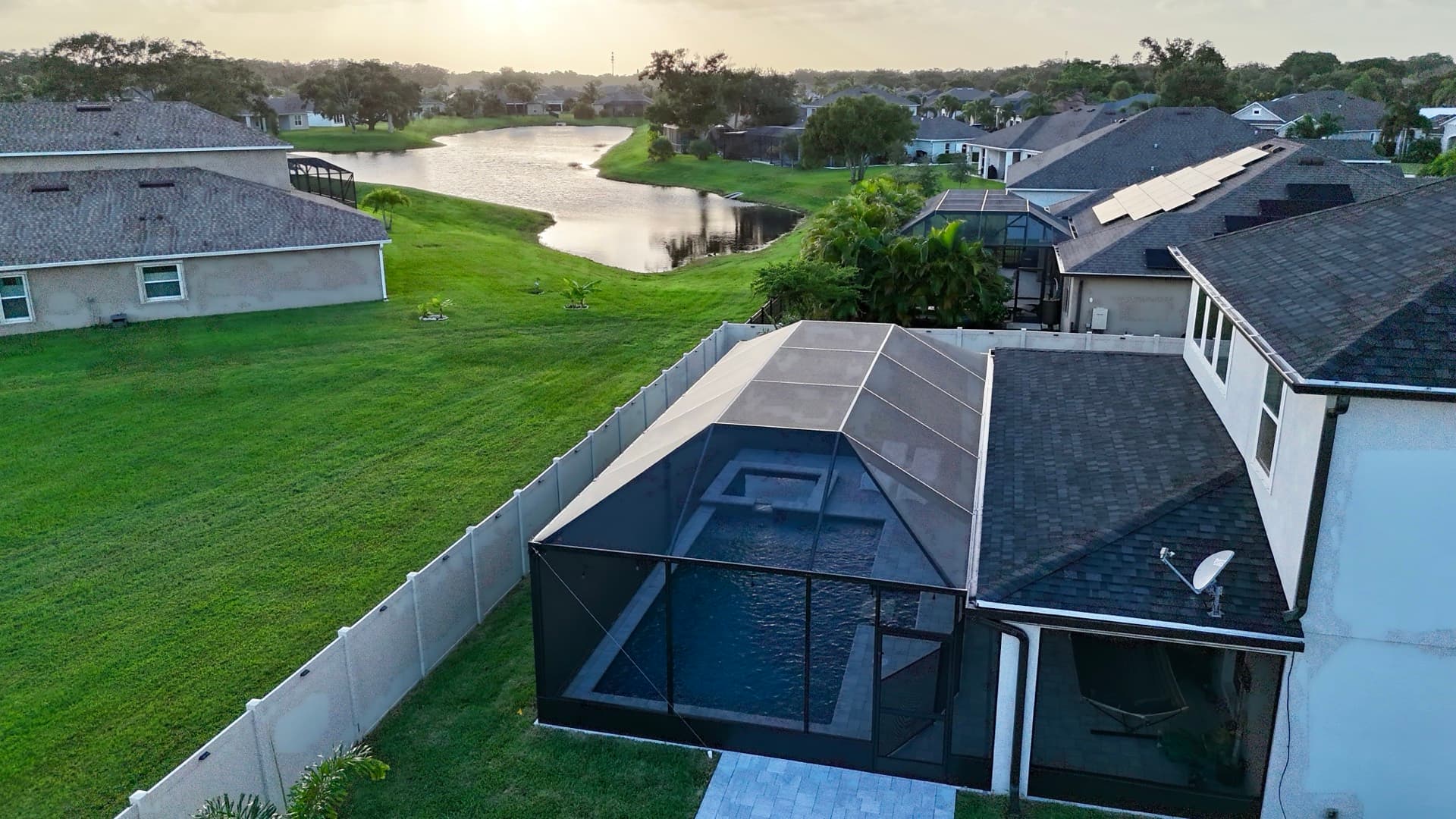 Aerial view of a screened pool enclosure built by Optimal Thermal Structures